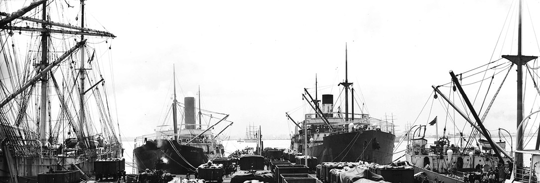 Black and white photo of ships at dock