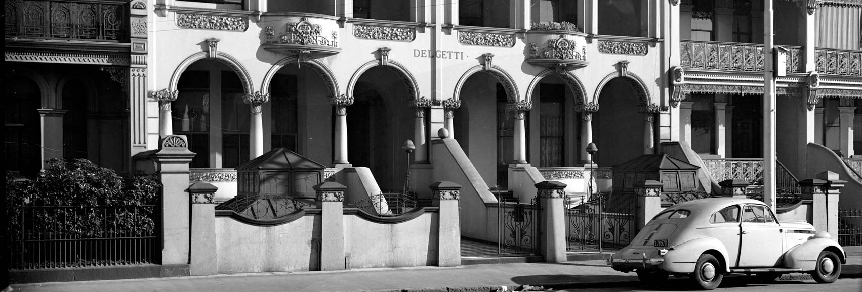 Black and white photo of a street scene, year and location unknown