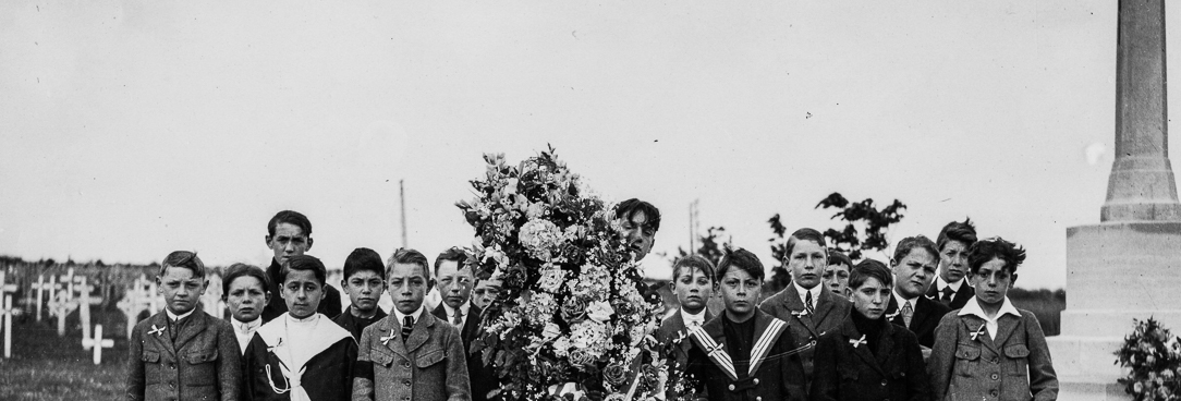 Black and white photo of boys at a cemetary