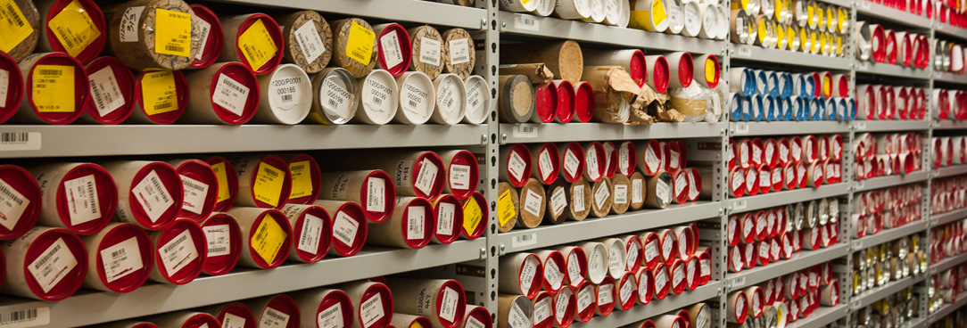 Records held in protective tubes on a shelf