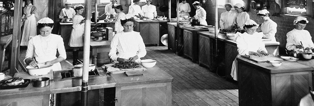 Black and white image of girls in kitchen 19th century