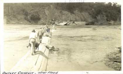 Men walking across a makeshift bridge 