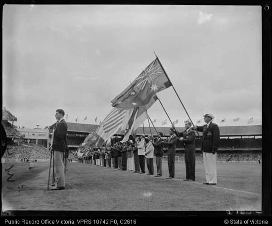 A photo of athletes lined up with flags