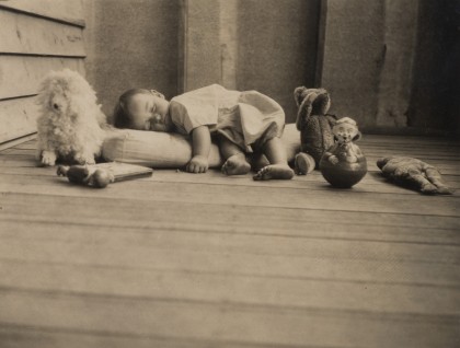 baby asleep among toys 