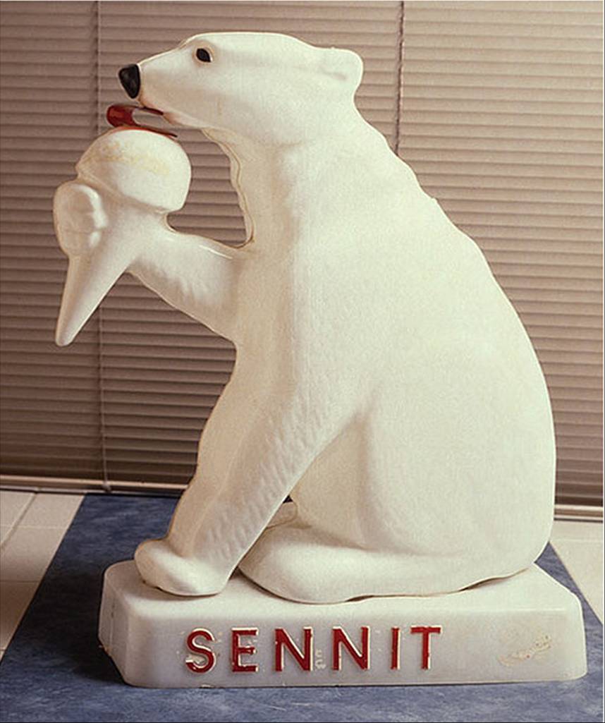 photo of a statue polar bear eating ice cream