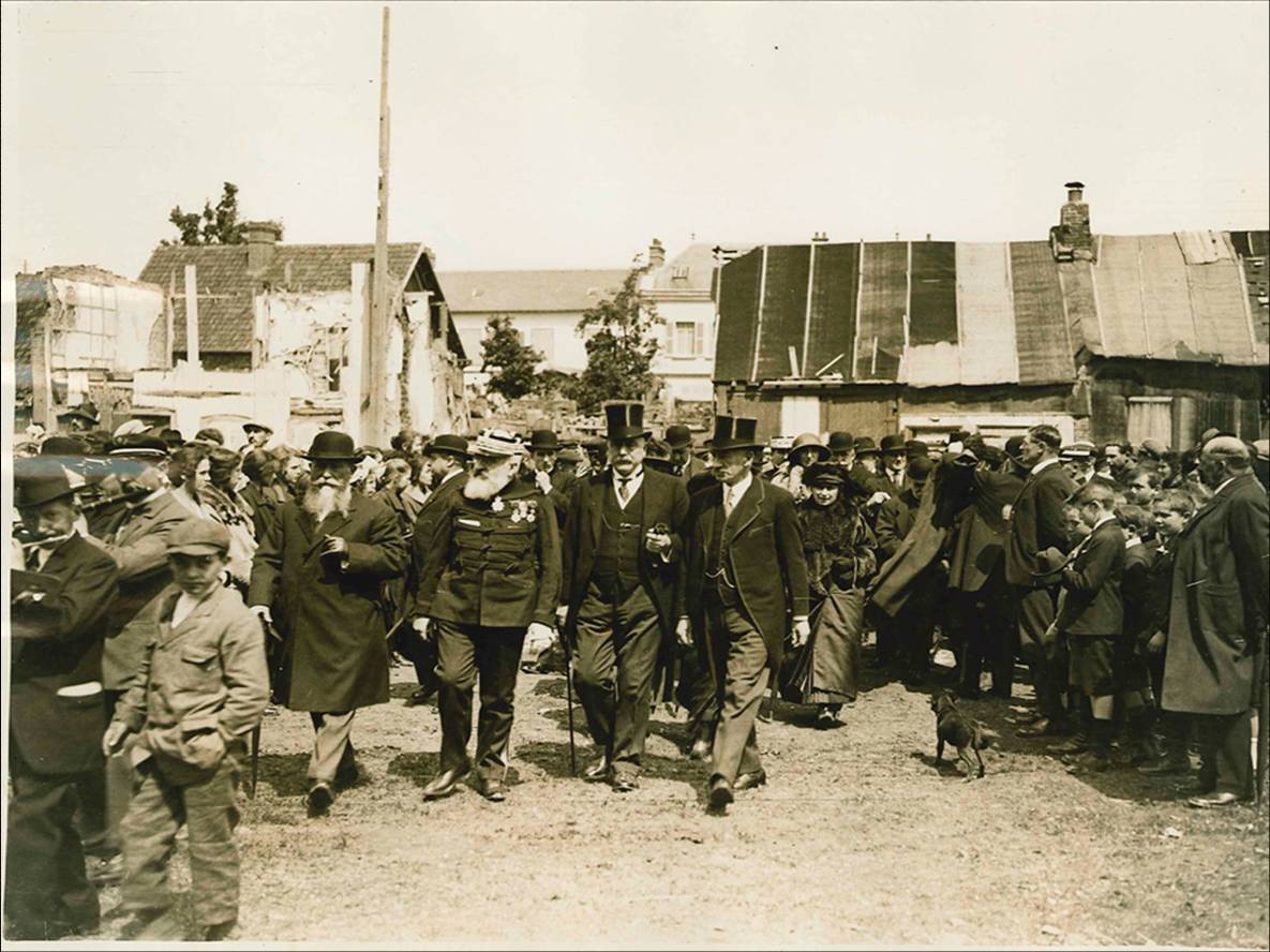 black and white photo of a group of people in the street