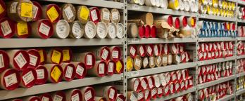 Records held in protective tubes on a shelf