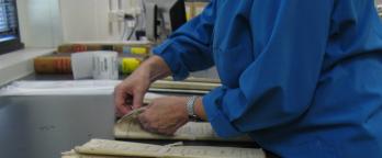 Image of archivist handling records 